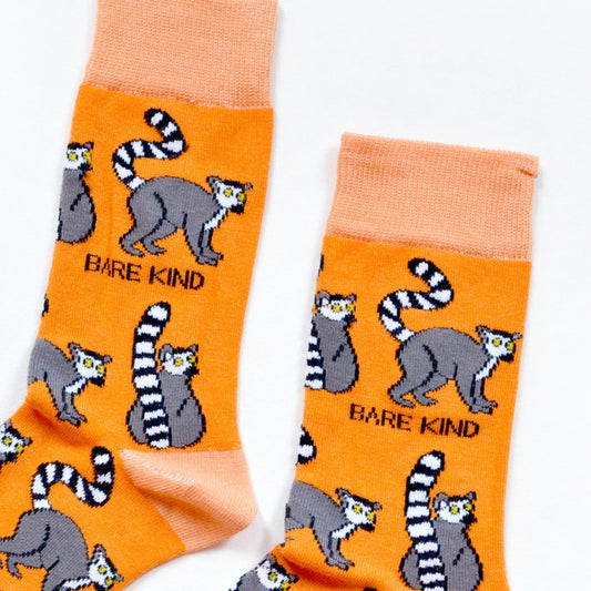 cuff closeup of flat lat of orange lemur bamboo socks