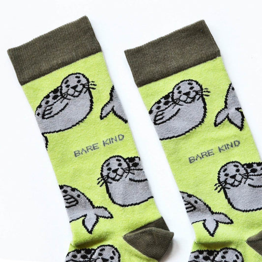 Green Save the Seals bamboo socks with animated seal patterns, made from soft plush fiber and supporting seal conservation.