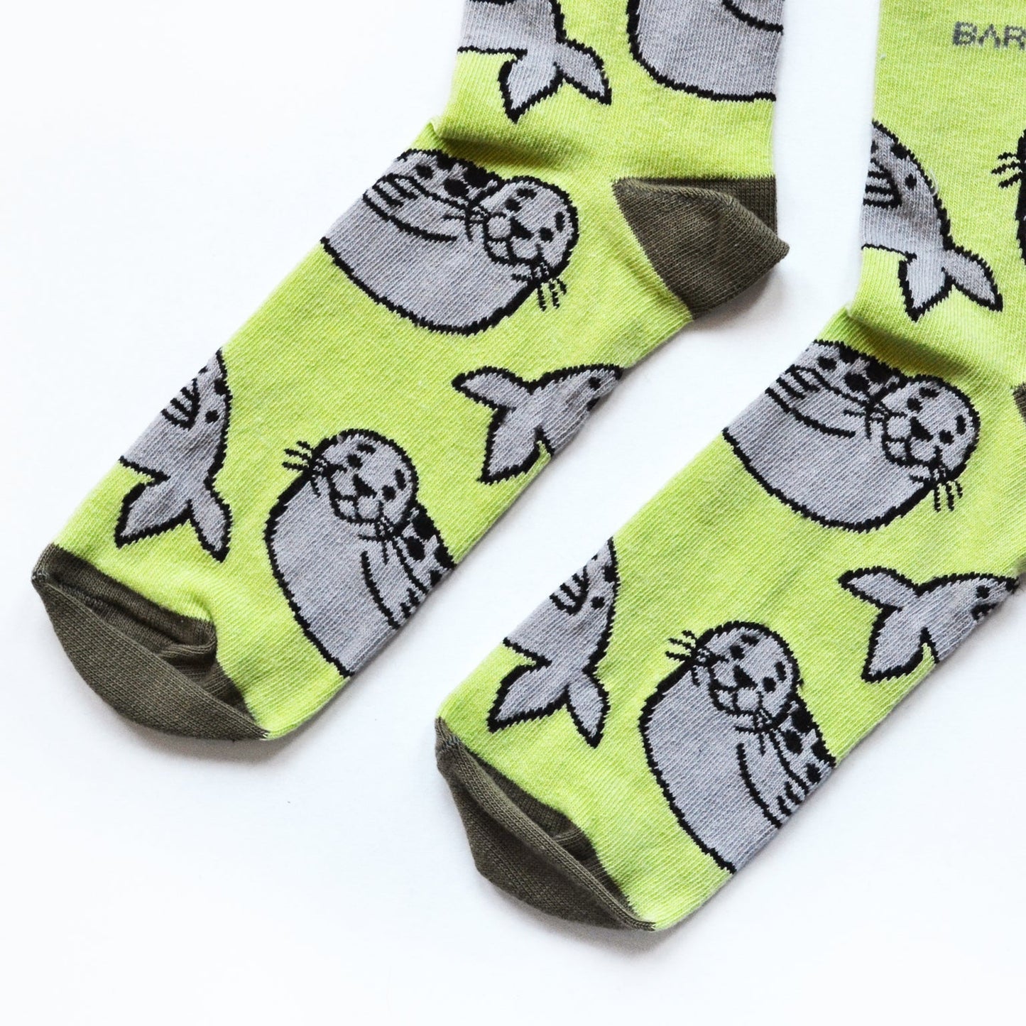 Two pairs of soft bamboo socks featuring blue penguin and green seal designs from the Bamboo Socks Duo collection