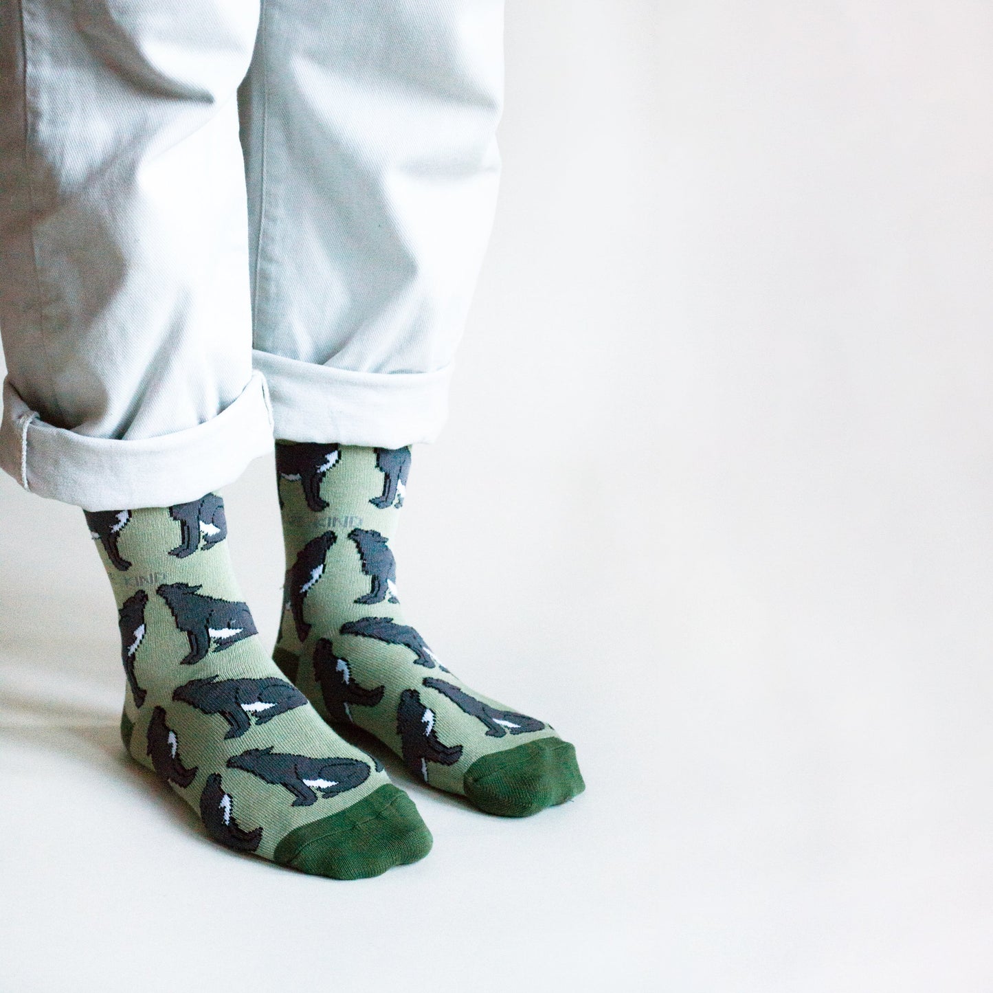 Green Save the Wolves bamboo socks with animated wolf design, sustainably sourced and comfortable