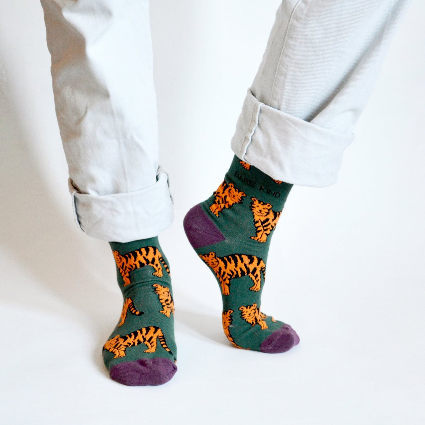 Green bamboo socks with animated tiger print, supporting Save the Tigers conservation efforts