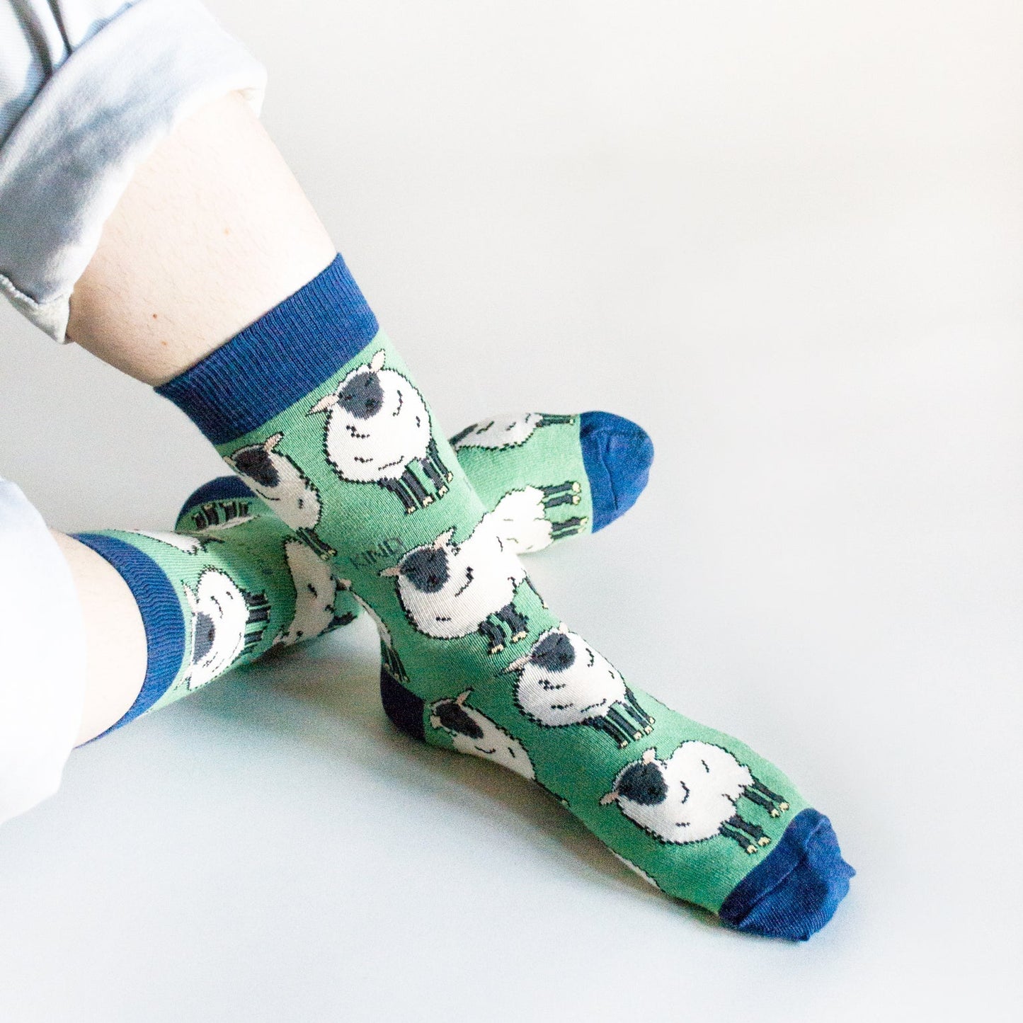 Green Save the Sheep Socks with animated sheep made from sustainable bamboo fiber