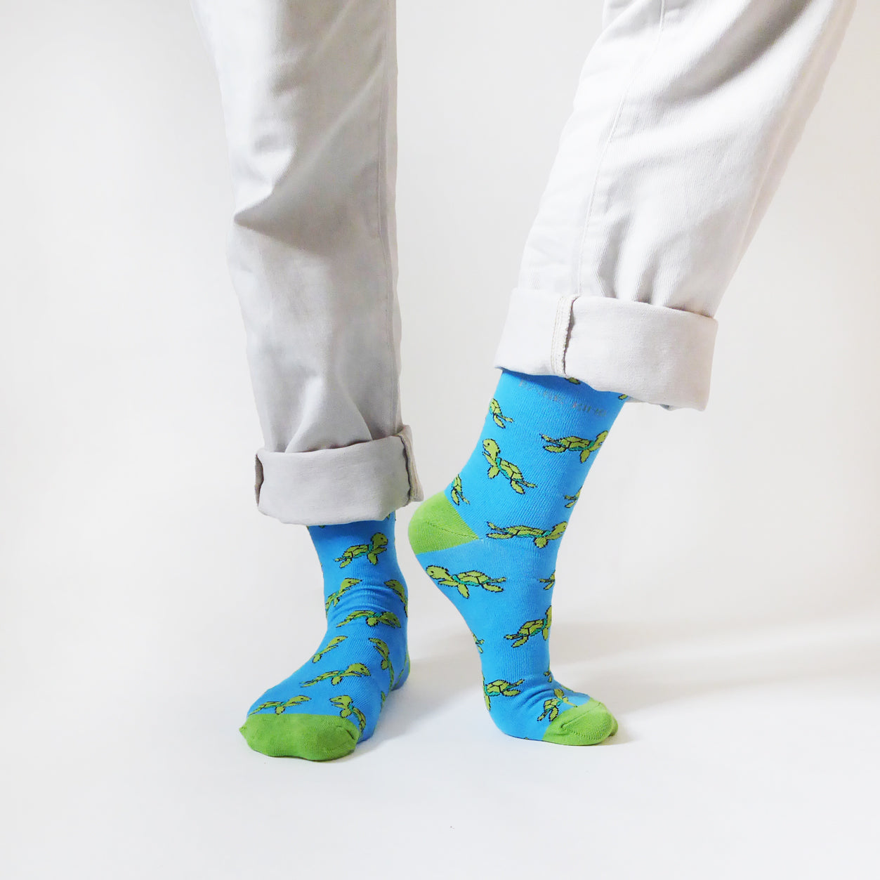 Sky blue breathable bamboo socks with green turtle design, supporting turtle conservation efforts