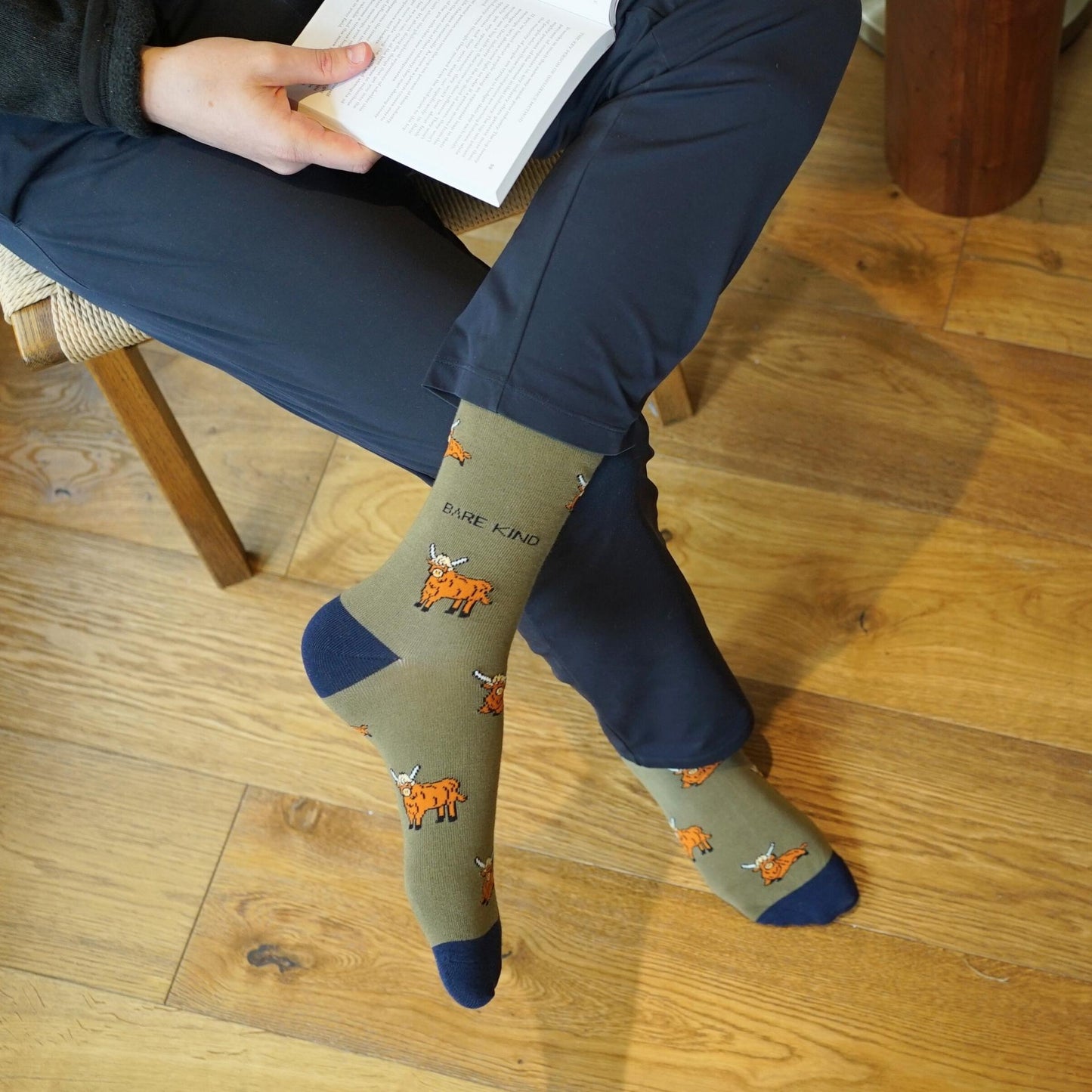 model wearing green highland cow bamboo socks