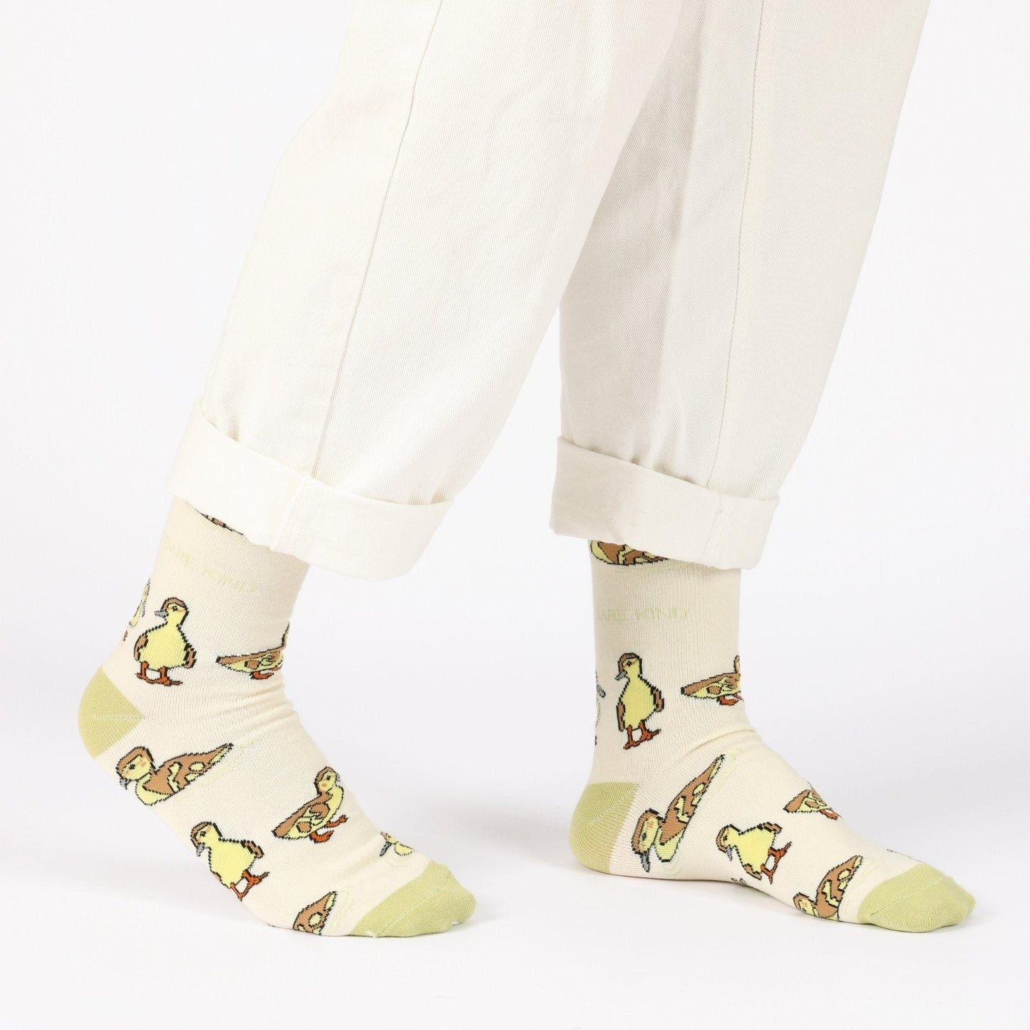model with white trousers wearing green ducklings bamboo socks