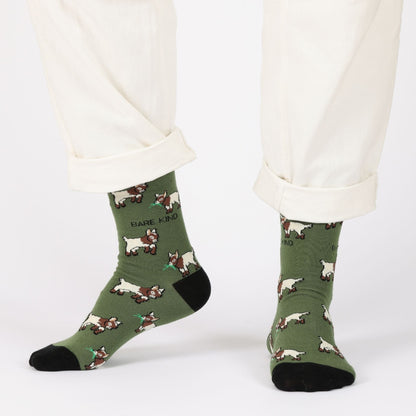 model with white trousers wearing green goats bamboo socks