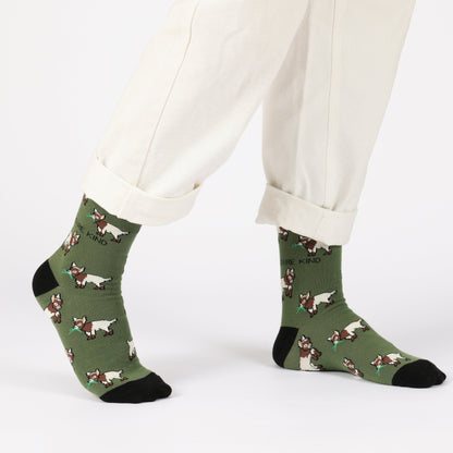 model with white trousers wearing green goats bamboo socks