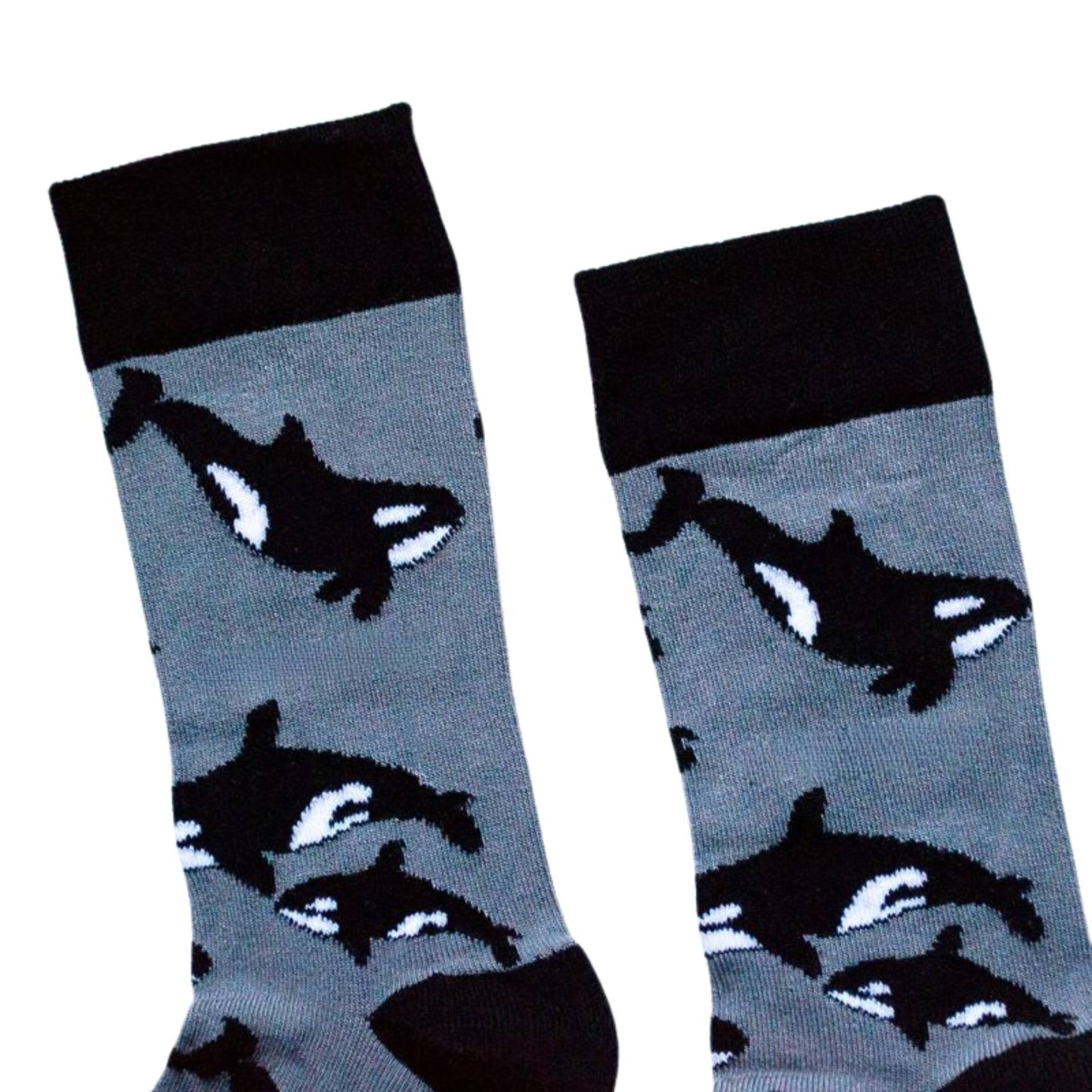 Pair of socks with orca whale design on a light gray background