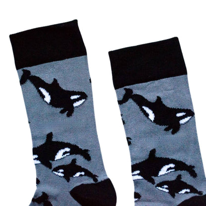 Pair of socks with orca whale design on a light gray background