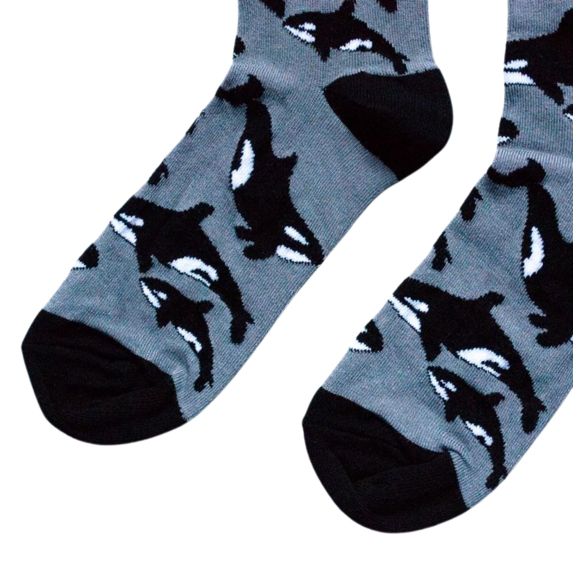Gray socks with black whale pattern on a white background