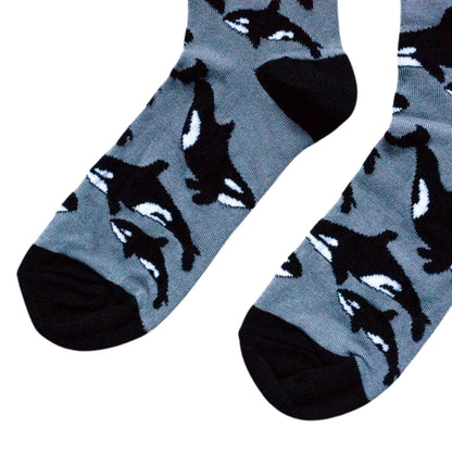 Gray socks with black whale pattern on a white background