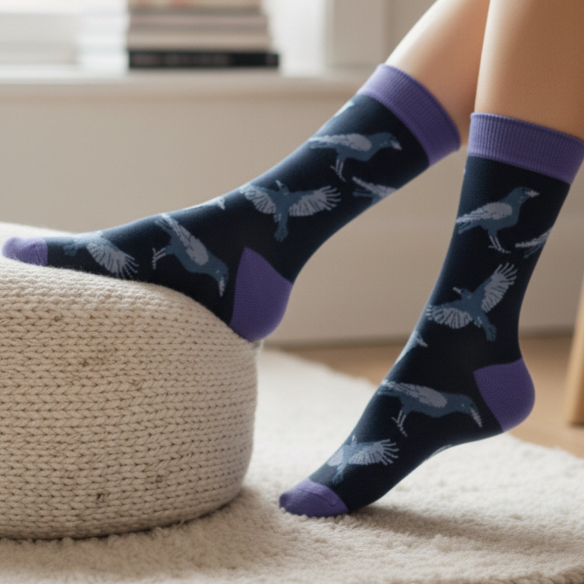 Person wearing navy socks with purple accents and raven pattern on a textured surface.