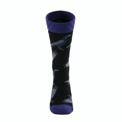 Black socks with blue raven patterns and purple accents on a white background