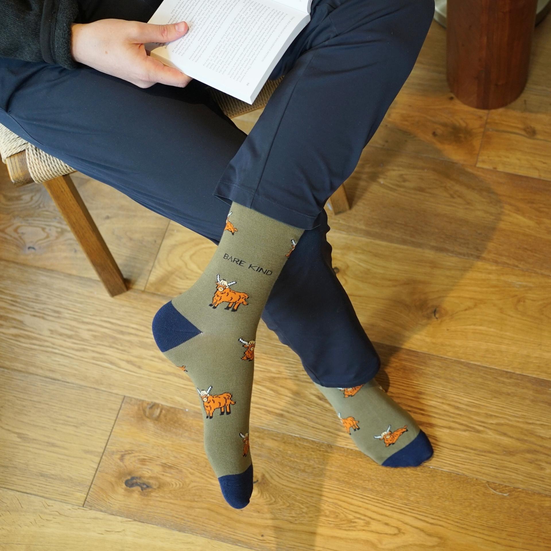 model wearing green highland cow bamboo socks